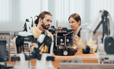 Robotic engineer monitoring robot arm connection for maintenance in science laboratory. Modern...