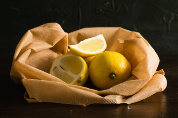 Earth day, recycling and zero waste concept. Juicy lemons in a brown reusable bag for fruits and...