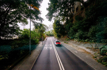 Obraz premium red cabs taxis on Victoria's Hill road in Hong Kong.