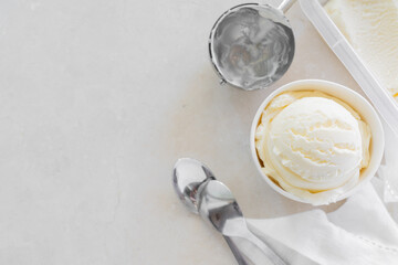 Fototapeta na wymiar Vanilla ice cream in white cup, marble background