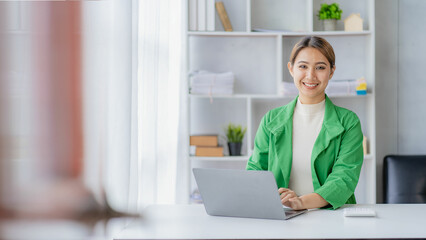 Beautiful Asian businesswoman in suit working with virtual computer in office Small business owner, person, freelancer, online marketing, sme, real estate marketing concept.