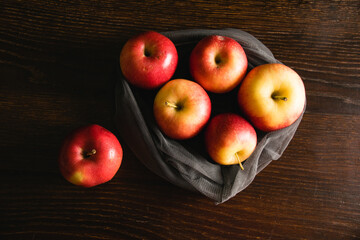 Delicious apples in a reusable net for fruits and vegetables. Earth day and waste recycling concept.