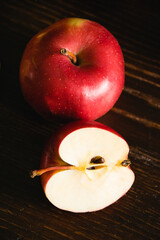 Sweet red sliced apples on a dark background with copy space
