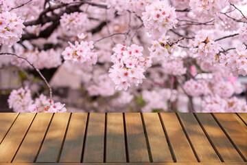 wooden table with pink flowers bokeh background