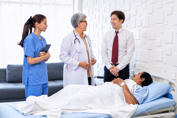 Hospital treatment room relative visit patient lay on bed doctor explain update illness condition