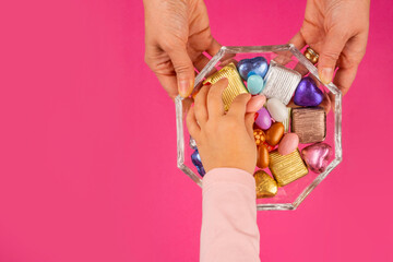 Sugar feast concept, top view image of sugar feast concept. Woman hands holding glass sweet bowl,...