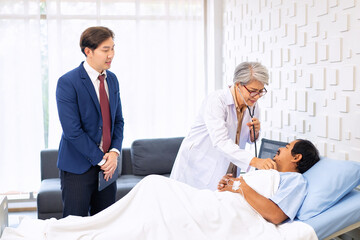 Fototapeta premium Hospital treatment room relative visit patient lay on bed doctor use stethoscope measurement