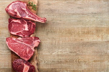 Raw prime steaks. Variety of fresh black angus prime meat steaks T-bone, New York, Ribeye,...