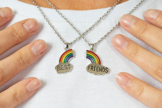 two pendants are best friends in the neckline on a white t-shirt. rainbow and cloud