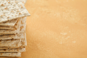 Matzah Passover celebration concept. Traditional ritual Jewish bread on sand color old wall background. Passover food. Pesach Jewish holiday of Passover celebration concept. Passover food.