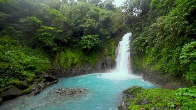 Catarata Rio Celeste, waterfall of blue river Rio Celeste, Parque Nacional Volcan Tenorio, Costa Rica, Central America, panning shot, slow motion