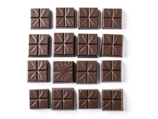 Tiles of dark chocolate isolated on white background.