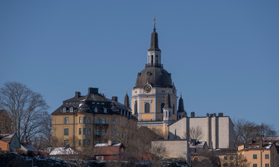 Fototapeta na wymiar The church Sofia Kyrka on a cliff in the district Södermalm at the bay Strömmen, a sunny spring day in Stockholm