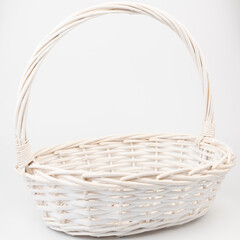 White wicker basket on white background. Used for storing items and reduce the waste of plastic bags.