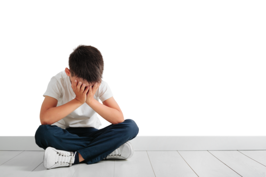 a child whose depression is sitting on the floor