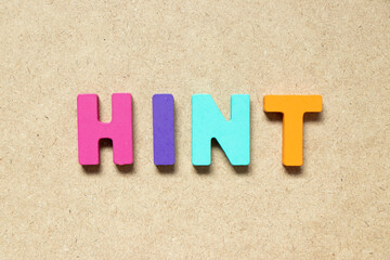 Color alphabet letter in word hint on wood background