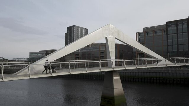 Time lapse of people walking over the Squiggly Bridge in Glasgow, Scotland