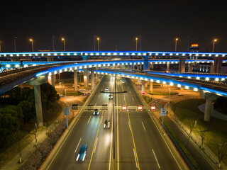 Aerial drone slow shutter night shot of urban elevated toll ring road junction and interchange overpass