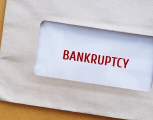 Envelope with text BANKRUPTCY -  legal process when one cannot repay debts to creditors and seek...