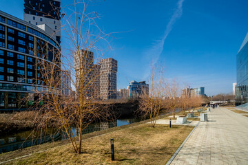 Fototapeta na wymiar New high-rise buildings along the river on a sunny day.