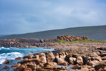 Granite rocks with red lichen at the wild coast of Cape Leeuwin, near Augusta, Western Australia
