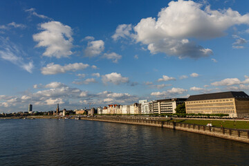 Fototapeta premium View to the city, river shore and clound in blue sky