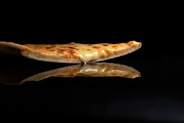 minimalistic shot of a delicious plain cheese pizza floating on a dark background