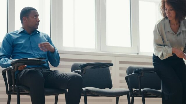 Anxious African American man and woman waiting for bank loan or job interview
