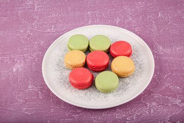 Colorful macarons cakes. Small french muffins. Sweet and colorful French macaroons. Colorful macarons on gray marble background. Top view. pastel colors.