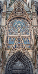 Architectural details of Notre Dame de Rouen Cathedral in the Normandy, France. Outdoor facade view of landmark featuring styles from Early Gothic to late Flamboyant and Renaissance architecture