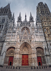 Fototapeta premium Outdoor facade view of Notre Dame de Rouen Cathedral in the Normandy, France. Architectural landmark featuring styles from Early Gothic to late Flamboyant and Renaissance architecture