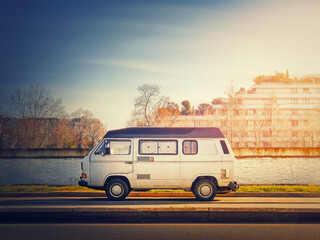 Old van parked on the edge of the street in the sunset sky background, Asnieres sur Seine, Paris...