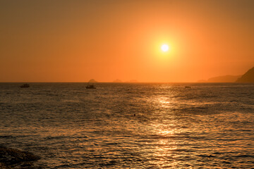 Fototapeta premium Sunset or sunrise in a orange sky at Arpoador beach