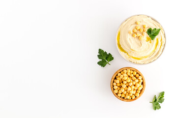 Bowl of chickpeas hummus with oil and herbs, top view