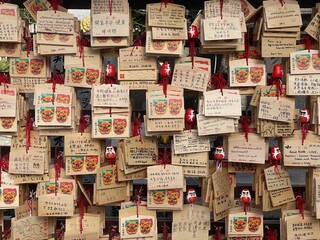 Fototapeta na wymiar Ema hangs at the Namba Yasaka Jinja in Osaka filled with prayers and wishes