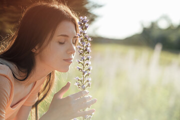 Celebrate Earth Month, Earth Day. Spend time in nature. Connect to nature is way to mitigate climate anxiety. Young woman, girl walks outdoors and enjoys nature