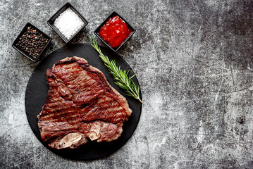 grilled T-bone steak on stone background with copy space for your text