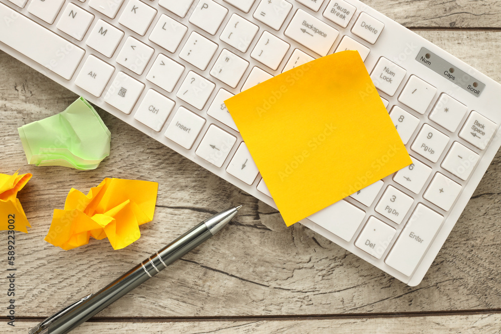 Poster empty yellow sticky paper note on laptop keyboard with copy space