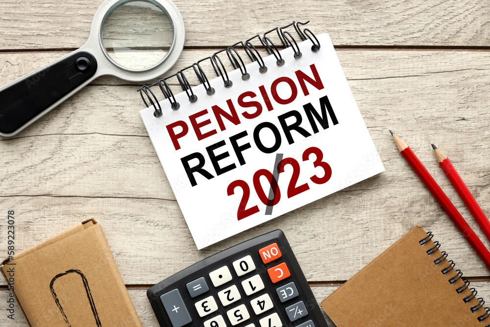 Poster pension reform concept. wooden background open notepad with text near calculator