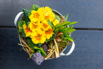 Shot from above of a beautiful bouquet of yellow flowers in a pot on the table