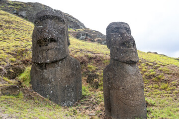 Moai Ko Kona He Roa (on the right) statue features a carving of a European ship on its front at...