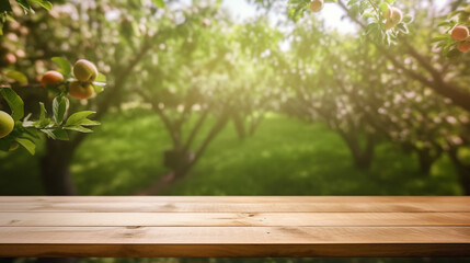 Empty wooden table top in front of a park with apple trees and pink flowers in the background