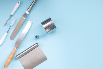 A set of tools for a pastry chef, a spatula for decorating a cake with cream, a ring cake mold