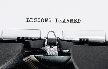 Text LESSONS LEARNED typed on retro typewriter