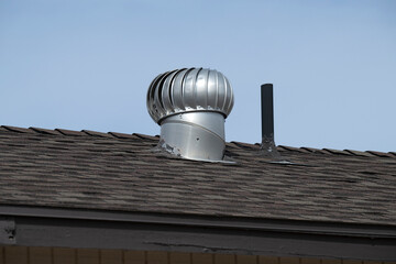 A metal vent on a house roof