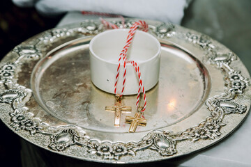 A close-up shot of two golden crosses on reflective plate in an Apostolic church before the...