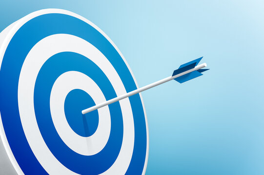 Round shaped target with arrow on blue background