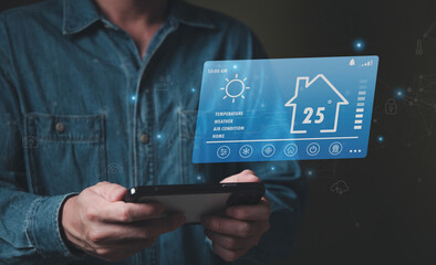 People hand using smartphone or computer laptop to access smart home application from internet wireless connection to control and monitoring smart device inside of the house. Internet of things.