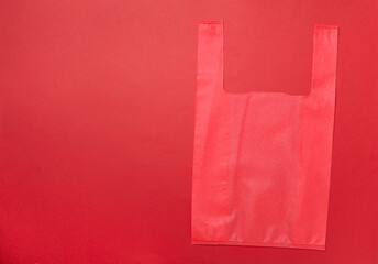 Biodegradable bag on color background, top view
