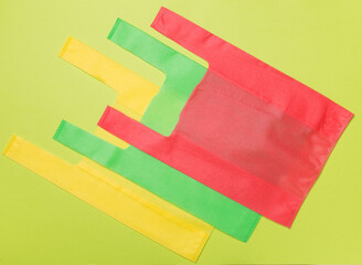 Biodegradable bags on color background, top view